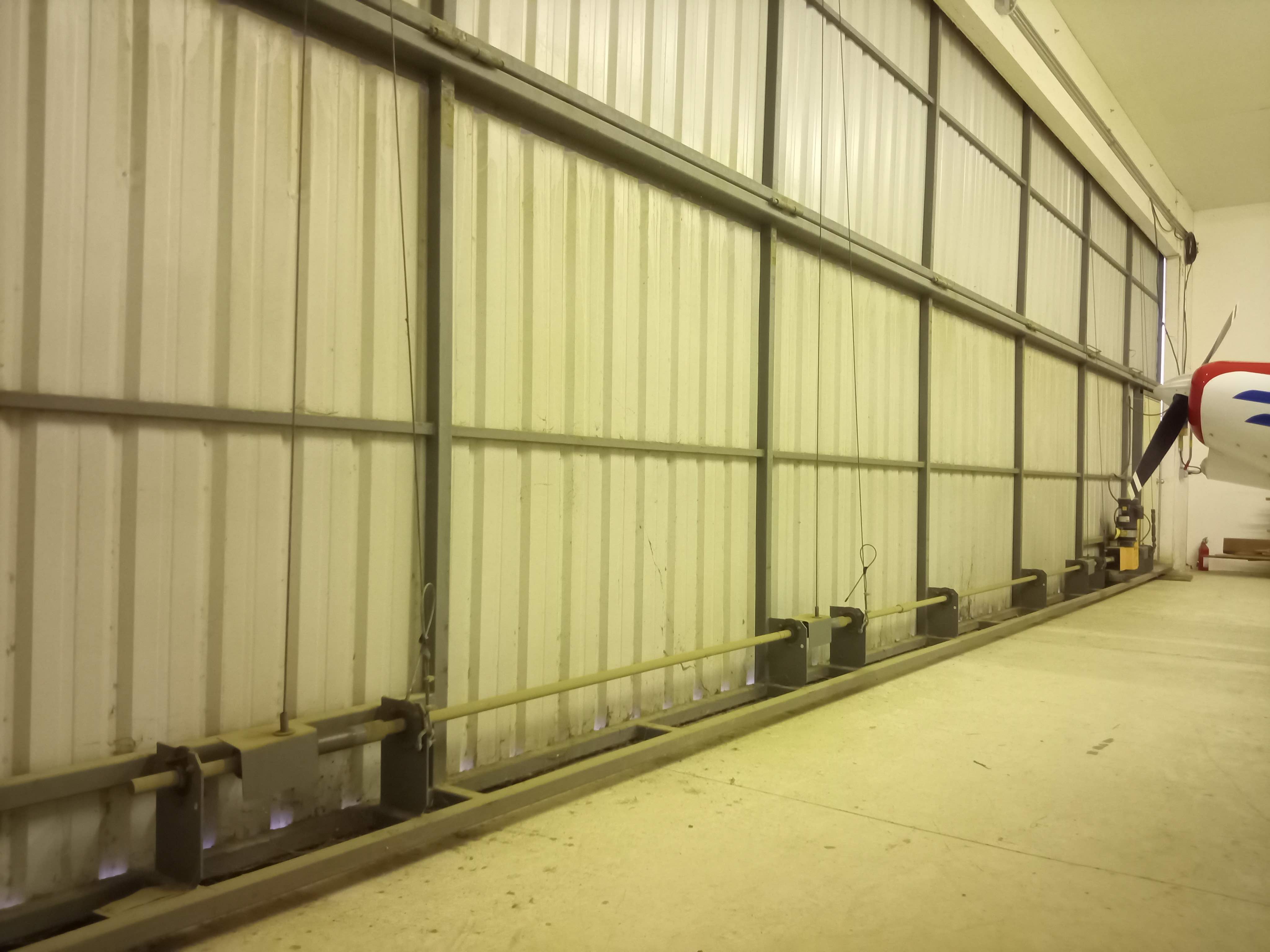 Hangar_115_-_8._inside_closed_Schweiss_bifold_door_looking_west.jpg